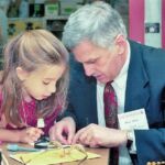 Bruce Alberts At Smith College with a little girl.