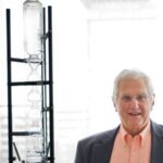 Bruce in his UCSF office with an old still from his lab.